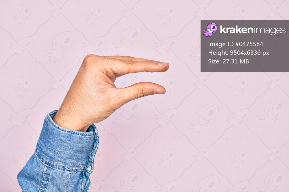 Hand of caucasian young man showing fingers over isolated pink background picking and taking invisible thing, holding object with fingers showing space