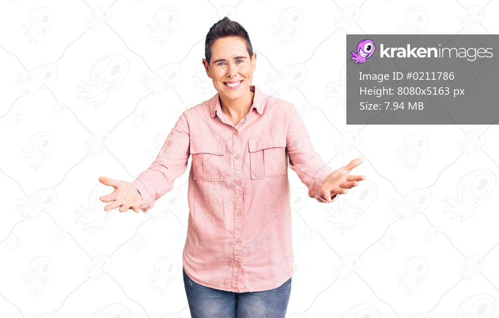 Young woman with short hair wearing casual clothes smiling cheerful offering hands giving assistance and acceptance. 