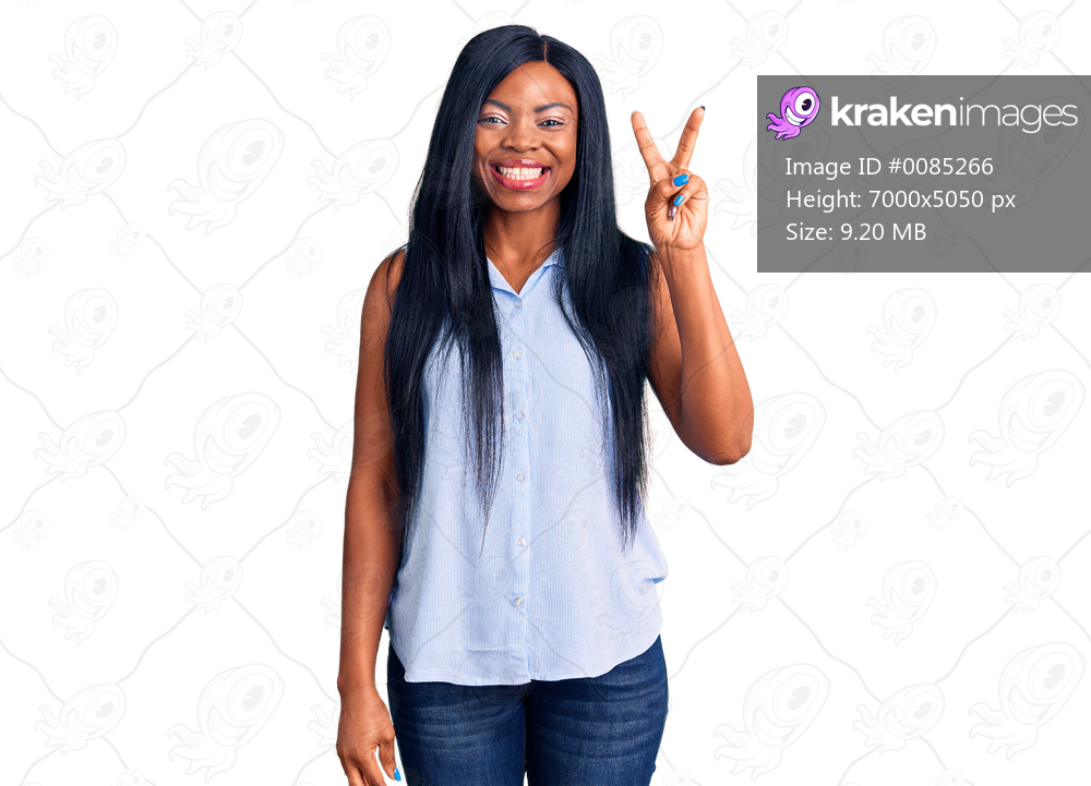 Young african american woman wearing casual clothes showing and pointing up with fingers number two while smiling confident and happy. 