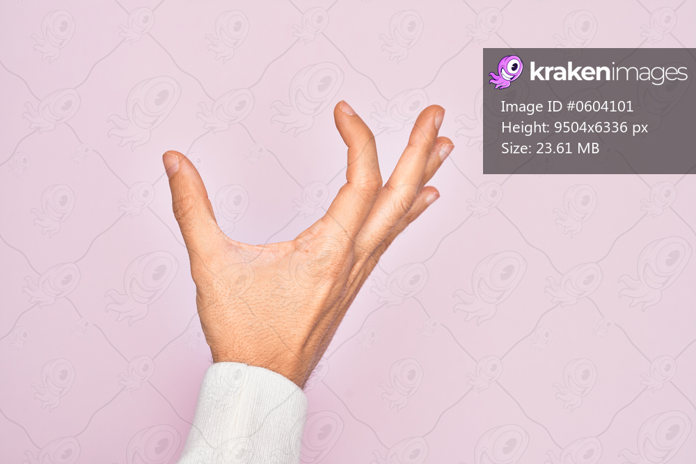 Hand of caucasian young man showing fingers over isolated pink background picking and taking invisible thing, holding object with fingers showing space