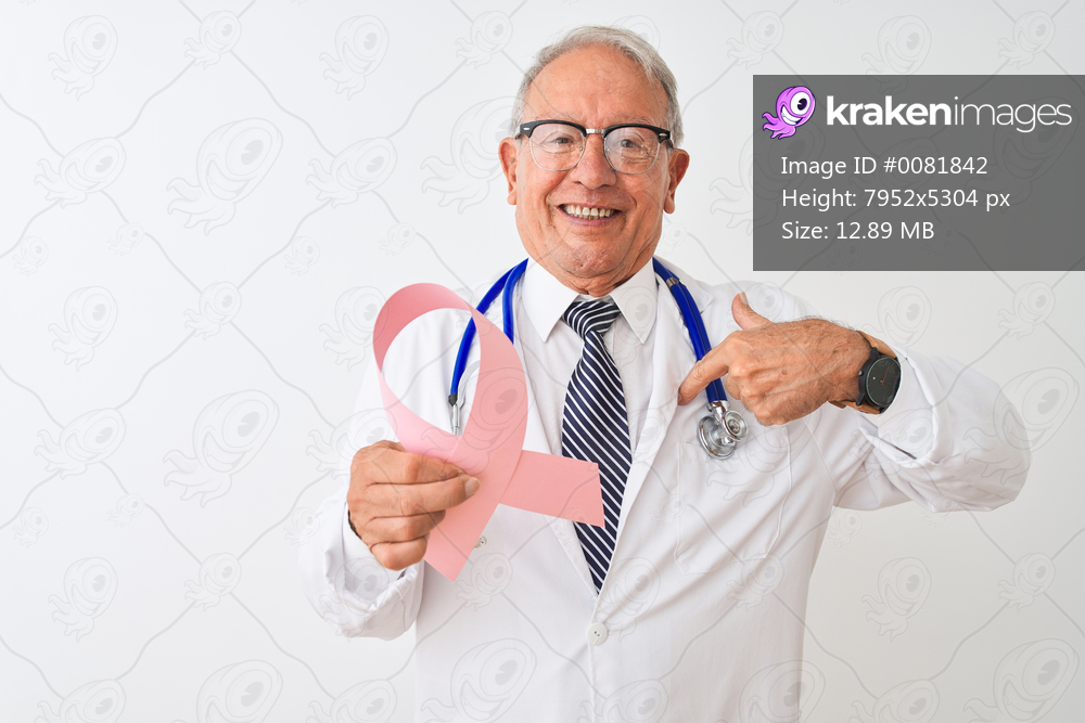 Senior grey-haired doctor man holding cancer ribbon over isolated white background with surprise face pointing finger to himself