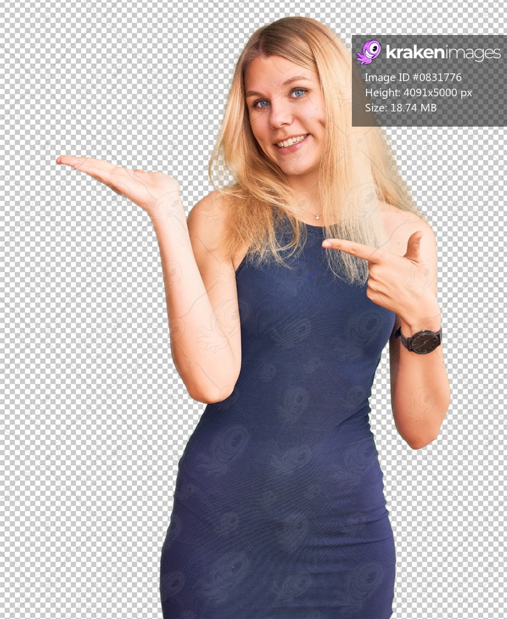 Young beautiful blonde woman wearing casual dress amazed and smiling to the camera while presenting with hand and pointing with finger.