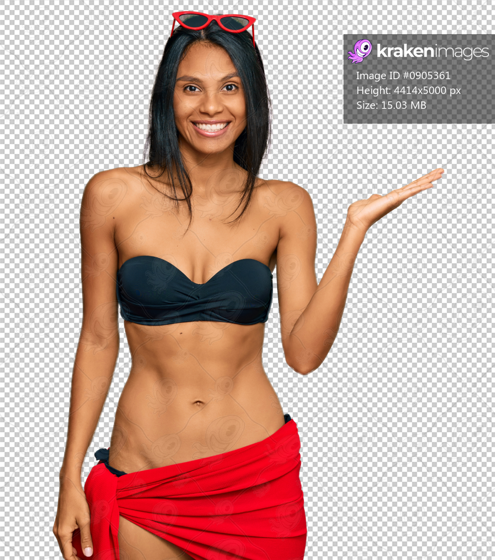 Young african american woman wearing bikini smiling cheerful presenting and pointing with palm of hand looking at the camera.