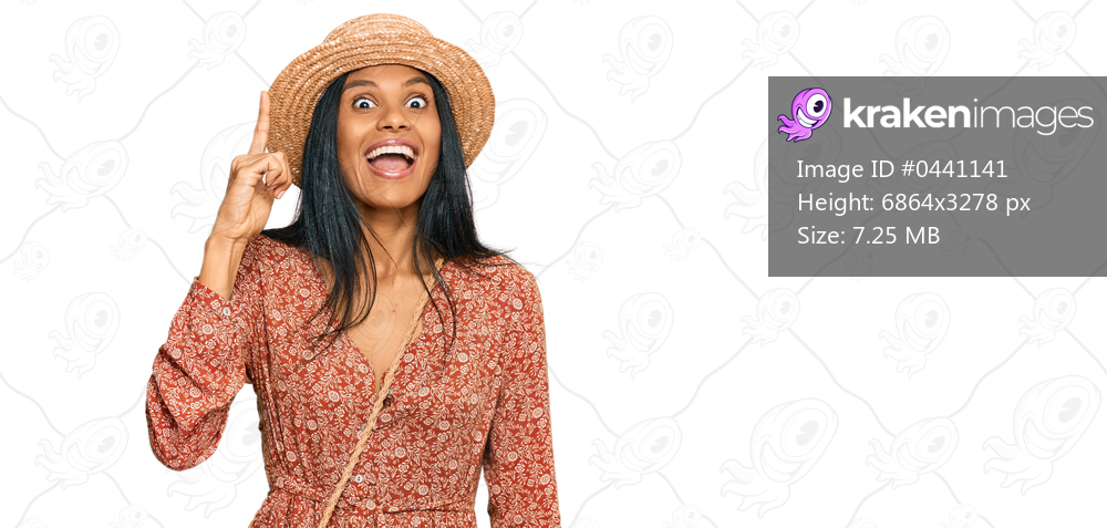 Young african american woman wearing summer hat pointing finger up with successful idea. exited and happy. number one. 