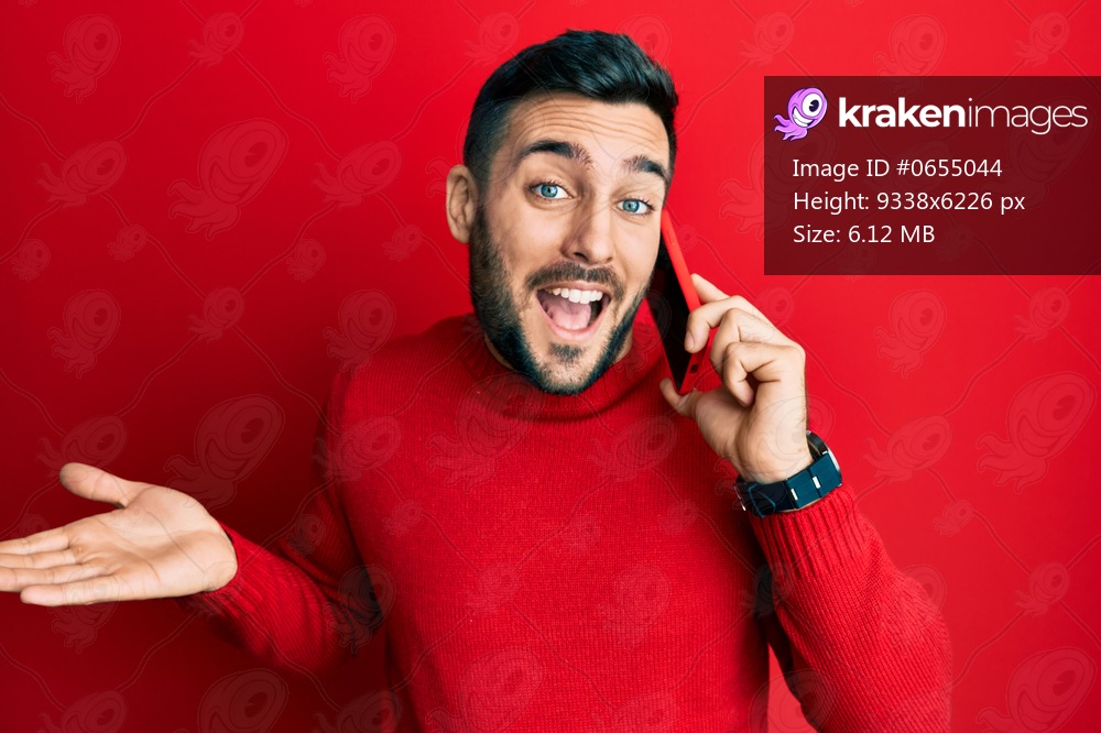 Young hispanic man having conversation talking on the smartphone celebrating achievement with happy smile and winner expression with raised hand 