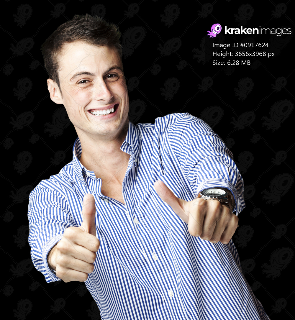 portrait of a handsome young man doing good symbol over black background
