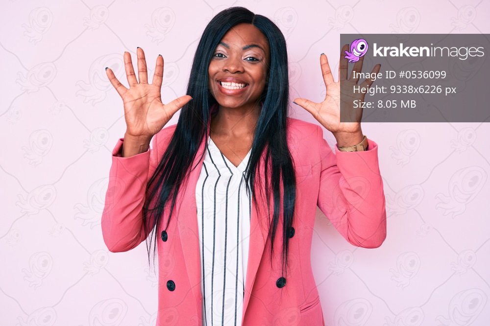 Young african american woman wearing business clothes showing and pointing up with fingers number ten while smiling confident and happy. 