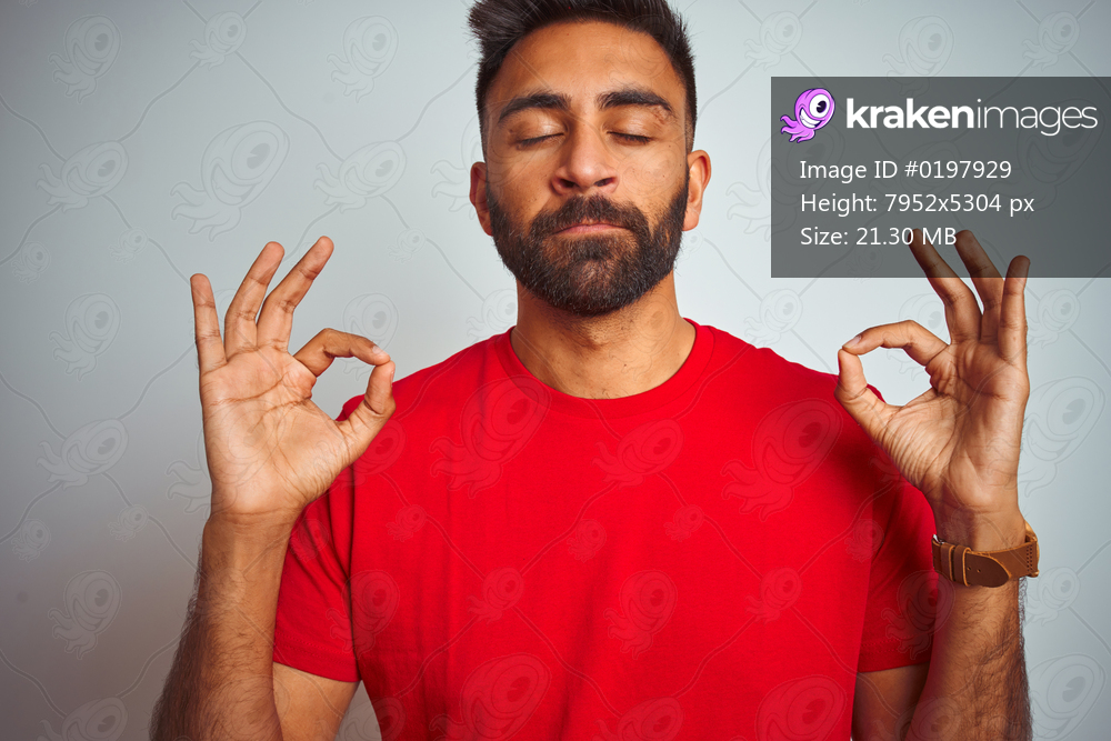 Young indian man wearing red t-shirt over isolated white background relax and smiling with eyes closed doing meditation gesture with fingers. Yoga concept.