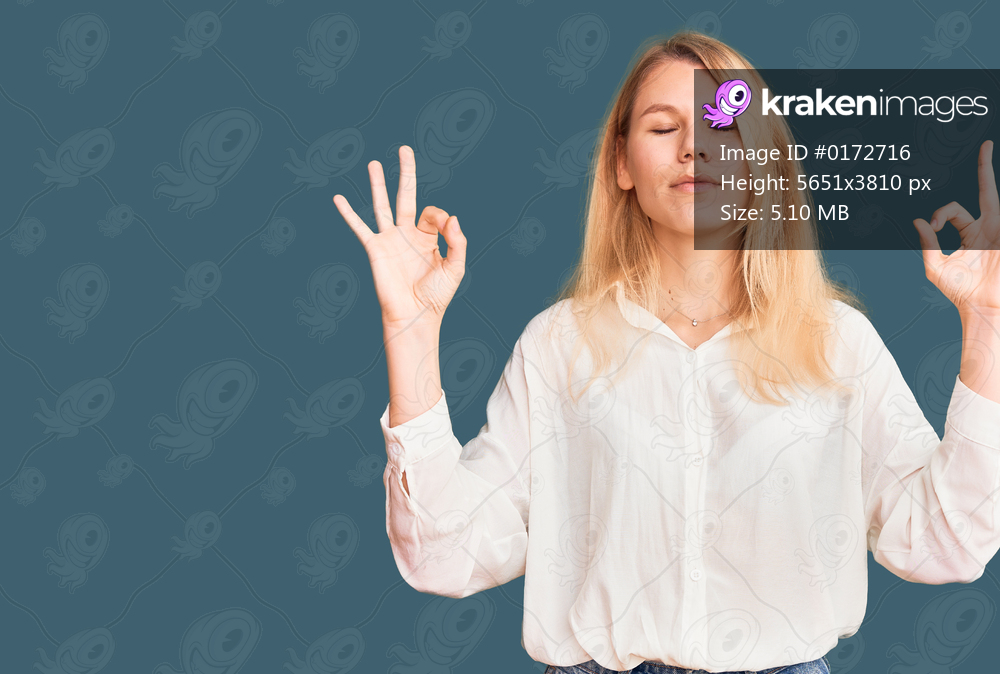 Young beautiful blonde woman wearing casual shirt relax and smiling with eyes closed doing meditation gesture with fingers. yoga concept. 