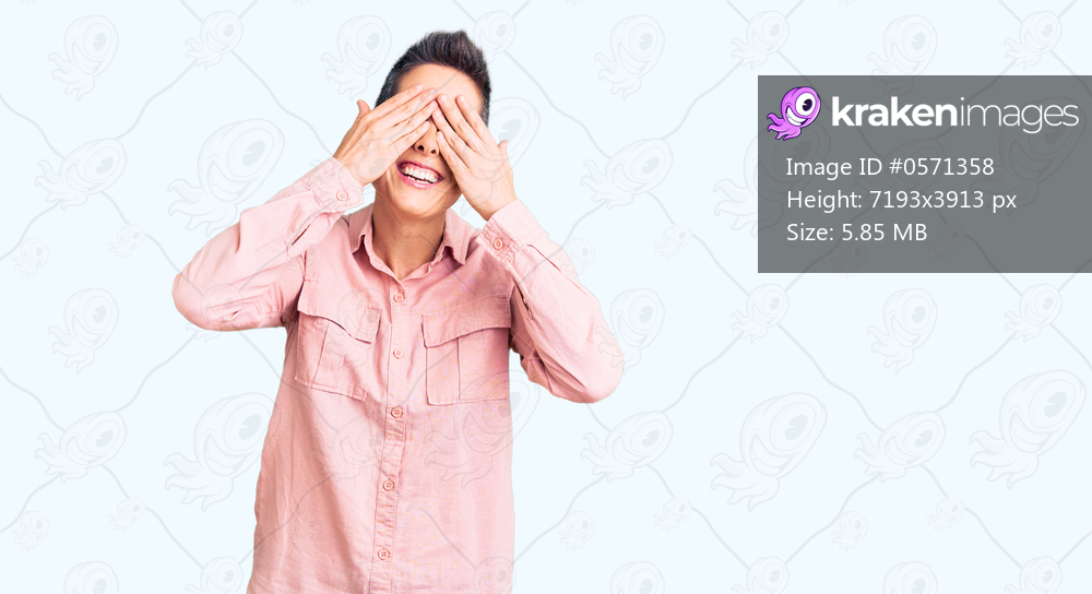 Young woman with short hair wearing casual clothes covering eyes with hands smiling cheerful and funny. blind concept. 