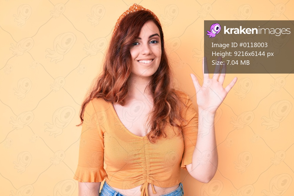 Young beautiful woman wearing casual clothes showing and pointing up with fingers number five while smiling confident and happy. 