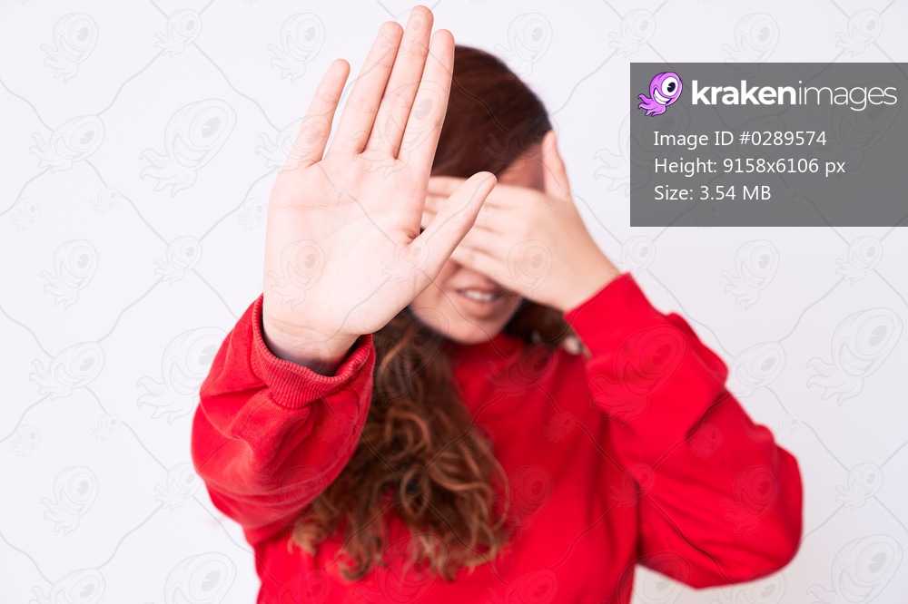 Young beautiful woman wearing casual clothes covering eyes with hands and doing stop gesture with sad and fear expression. embarrassed and negative concept. 