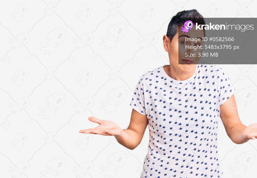 Young woman with short hair wearing casual clothes clueless and confused expression with arms and hands raised. doubt concept. 