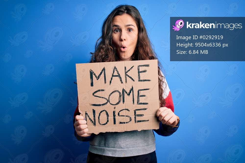 Beautiful activist woman holding banner with make some noise message over blue background scared in shock with a surprise face, afraid and excited with fear expression