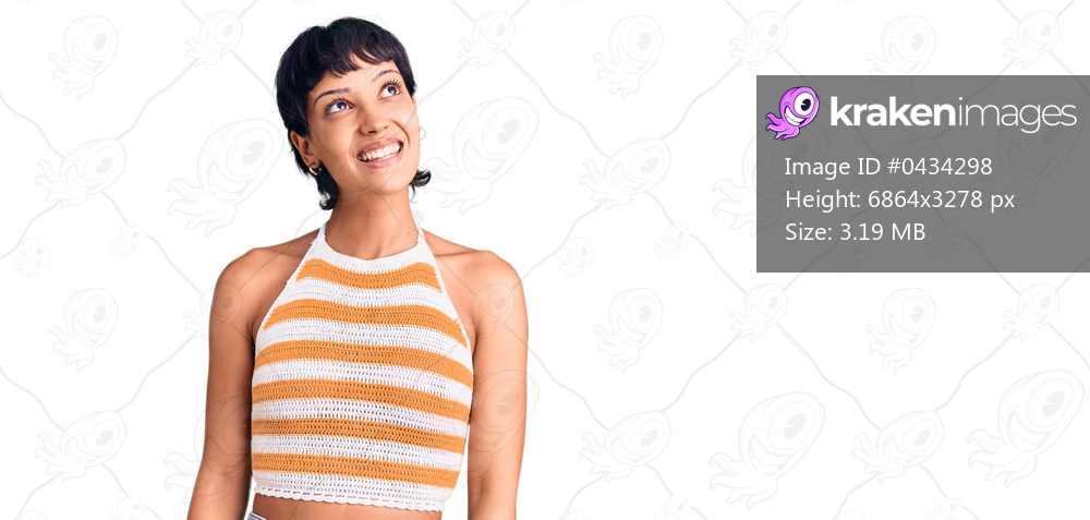 Young brunette woman with short hair wearing casual clothes smiling looking to the side and staring away thinking. 