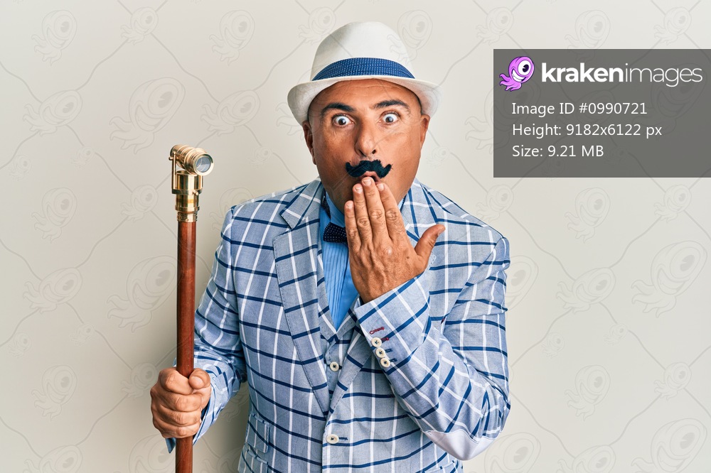 Mature middle east man with mustache wearing vintage and elegant fashion style covering mouth with hand, shocked and afraid for mistake. surprised expression 