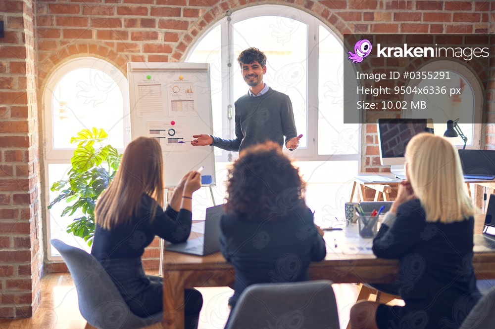 Group of business workers working together in a meeting. One of them making presentation to colleagues at the office