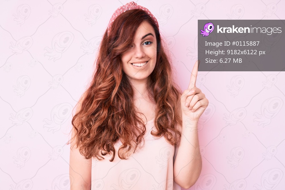 Young beautiful woman wearing casual clothes pointing finger up with successful idea. exited and happy. number one. 