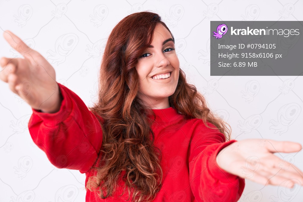 Young beautiful woman wearing casual clothes looking at the camera smiling with open arms for hug. cheerful expression embracing happiness. 