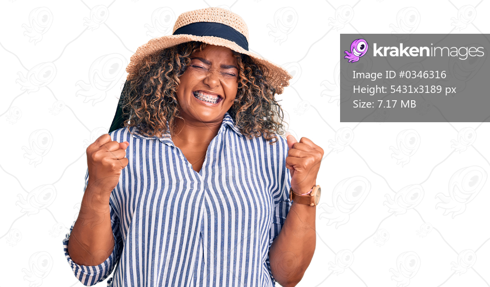 Young african american plus size woman wearing summer hat excited for success with arms raised and eyes closed celebrating victory smiling. winner concept. 