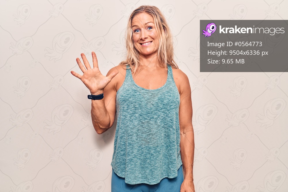 Middle age caucasian blonde woman wearing sportswear showing and pointing up with fingers number five while smiling confident and happy. 