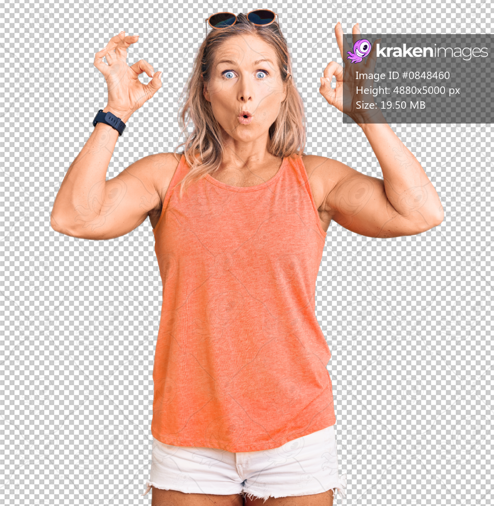 Middle age fit blonde woman wearing casual summer clothes and sunglasses looking surprised and shocked doing ok approval symbol with fingers. crazy expression