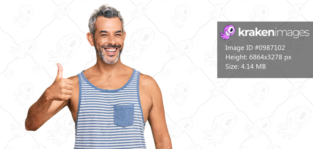 Middle age grey-haired man wearing casual style with sleeveless shirt smiling happy and positive, thumb up doing excellent and approval sign 