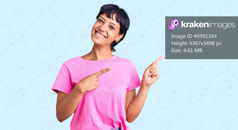 Young brunette woman with short hair wearing casual clothes smiling and looking at the camera pointing with two hands and fingers to the side. 