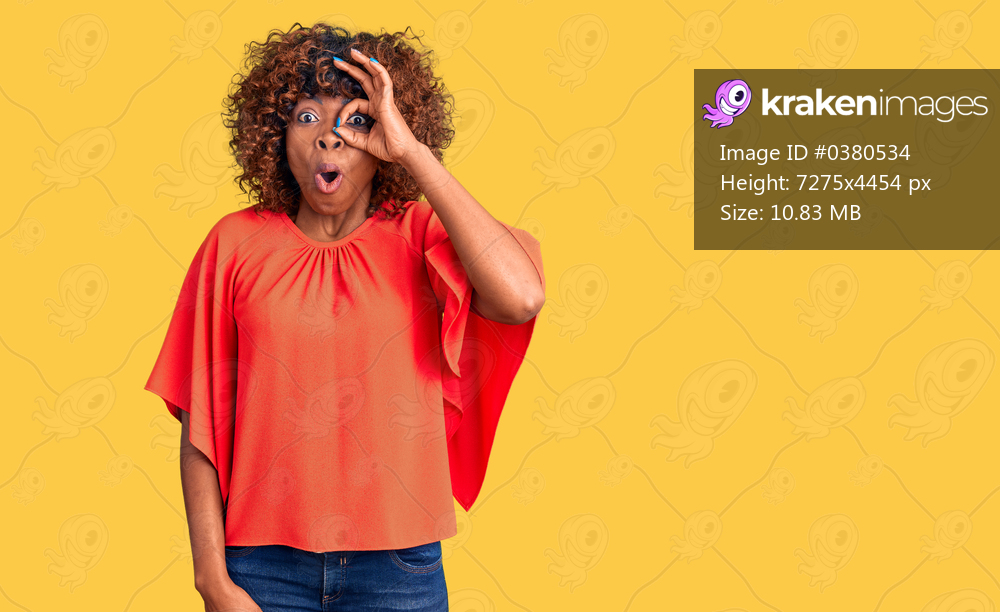 Young african american woman wearing casual clothes doing ok gesture shocked with surprised face, eye looking through fingers. unbelieving expression. 