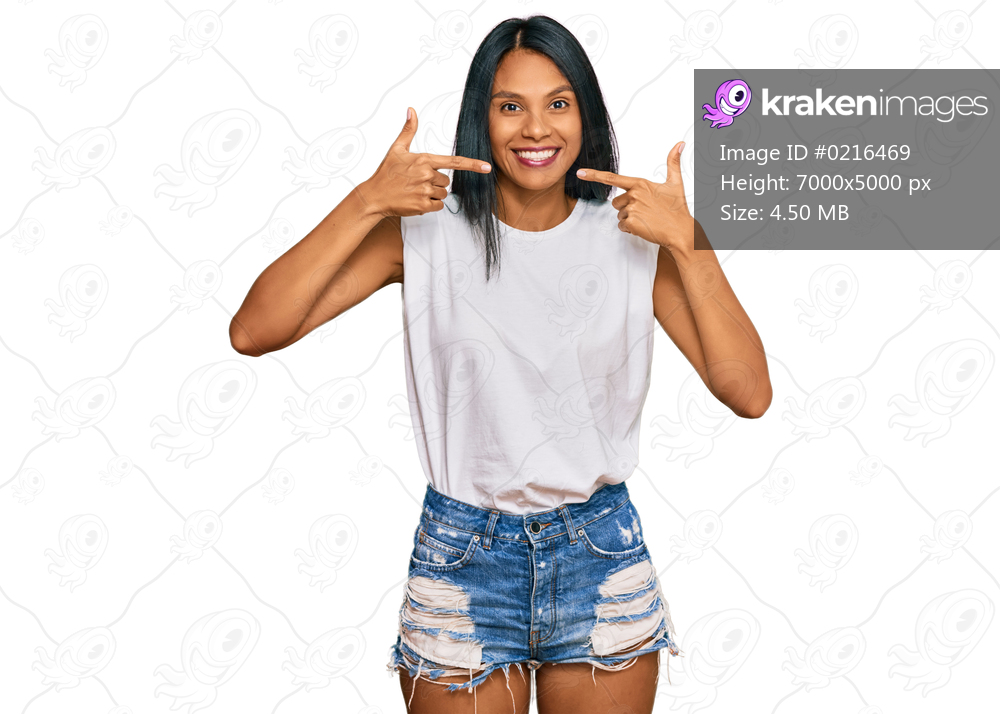 Young african american woman wearing casual clothes smiling cheerful showing and pointing with fingers teeth and mouth. dental health concept. 