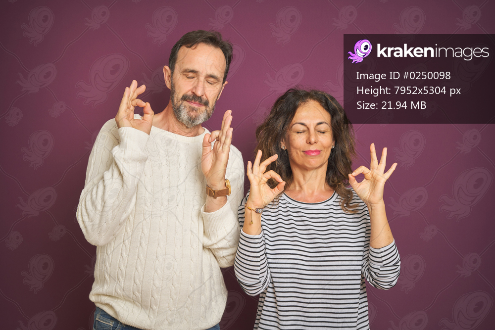 Beautiful middle age couple wearing winter sweater over isolated purple background relax and smiling with eyes closed doing meditation gesture with fingers. Yoga concept.