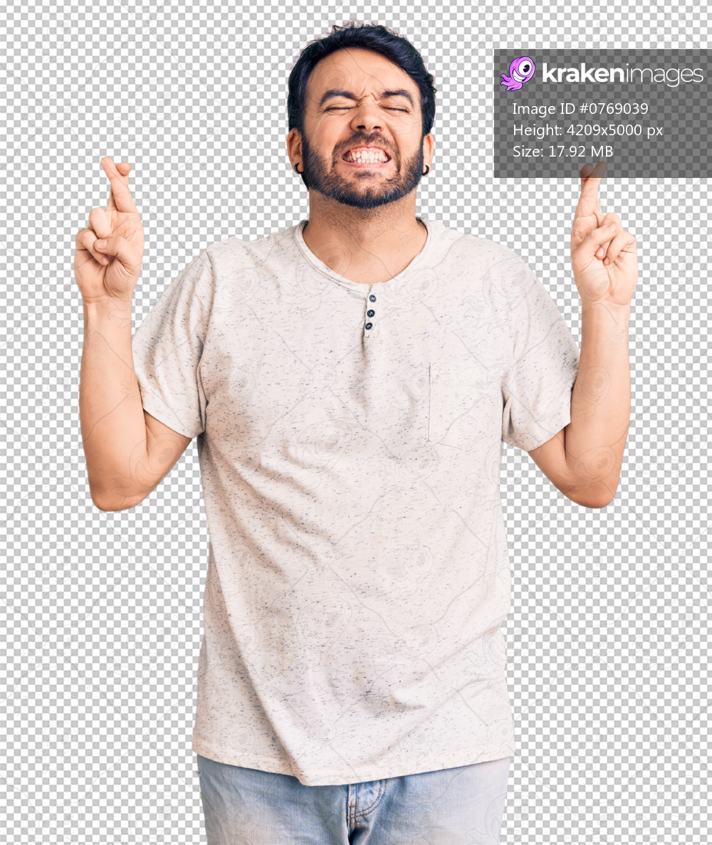 Young hispanic man wearing casual clothes gesturing finger crossed smiling with hope and eyes closed. luck and superstitious concept.