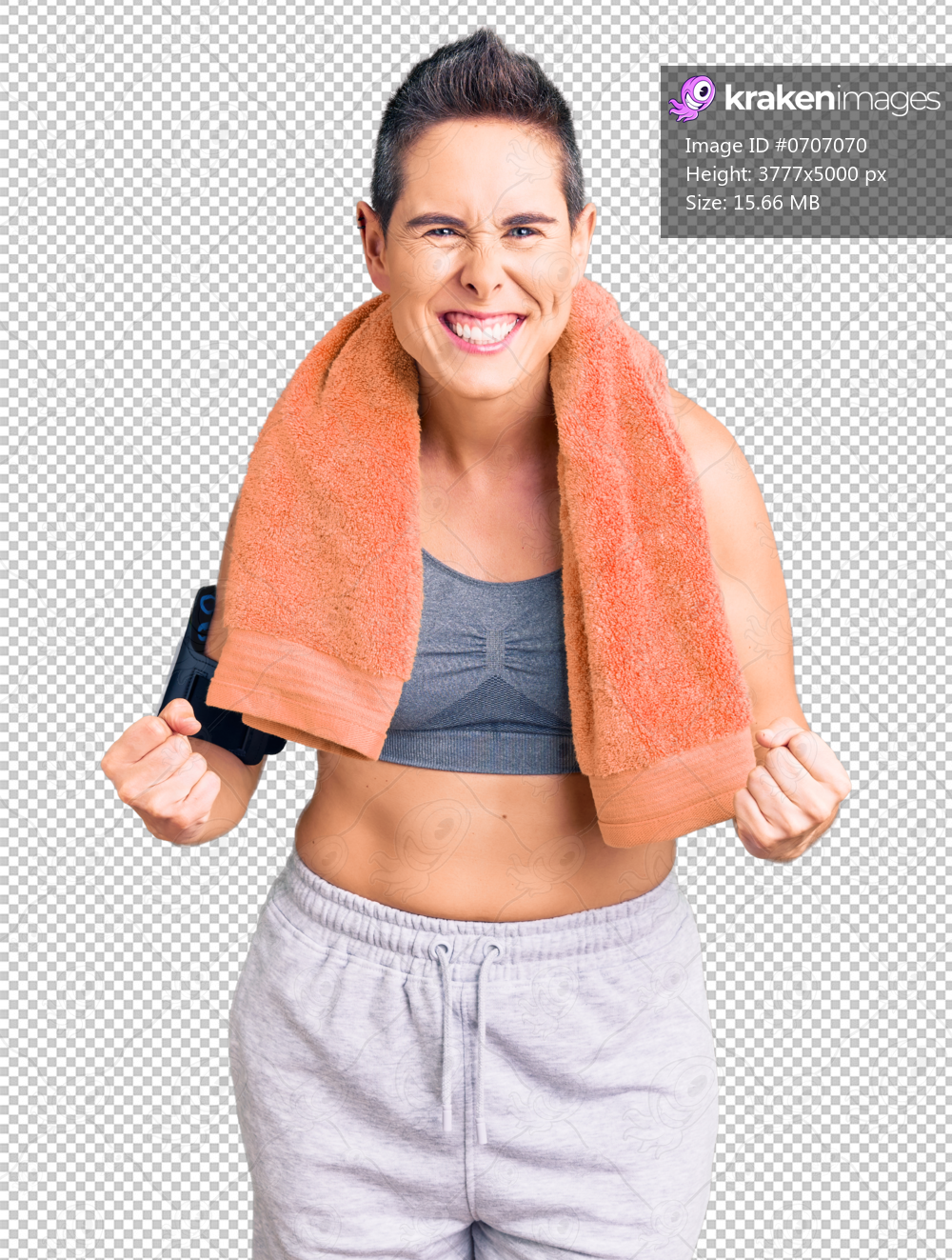 Young woman with short hair wearing sportswear and towel using smartphone very happy and excited doing winner gesture with arms raised, smiling and screaming for success. celebration concept.