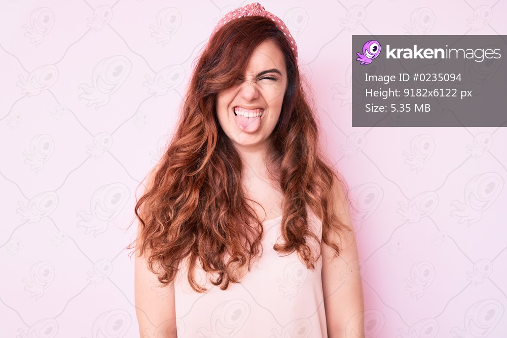 Young beautiful woman wearing casual clothes sticking tongue out happy with funny expression. emotion concept. 