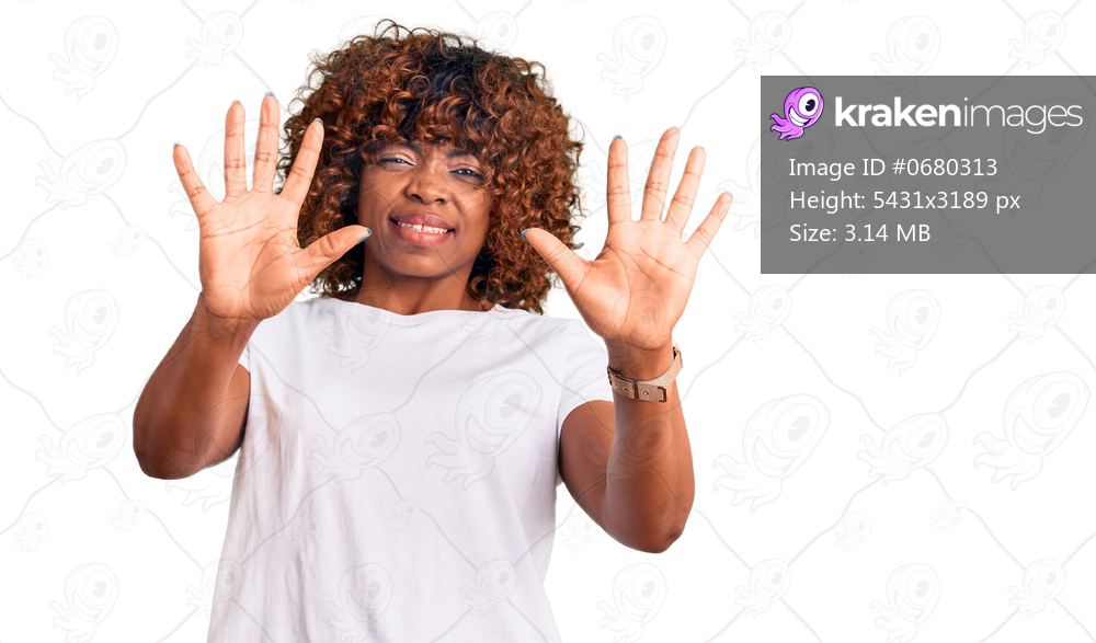 Young african american woman wearing casual white tshirt afraid and terrified with fear expression stop gesture with hands, shouting in shock. panic concept. 