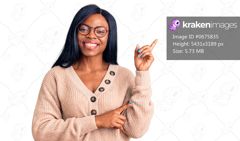 Young african american woman wearing casual clothes smiling happy pointing with hand and finger to the side 