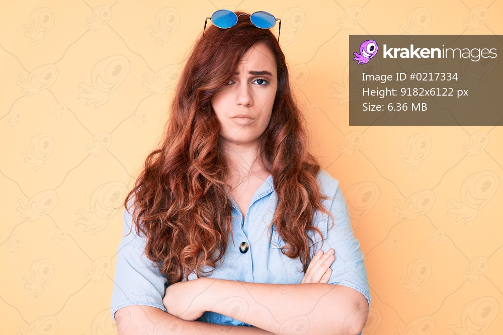 Young beautiful woman wearing casual clothes and sunglasses skeptic and nervous, disapproving expression on face with crossed arms. negative person. 