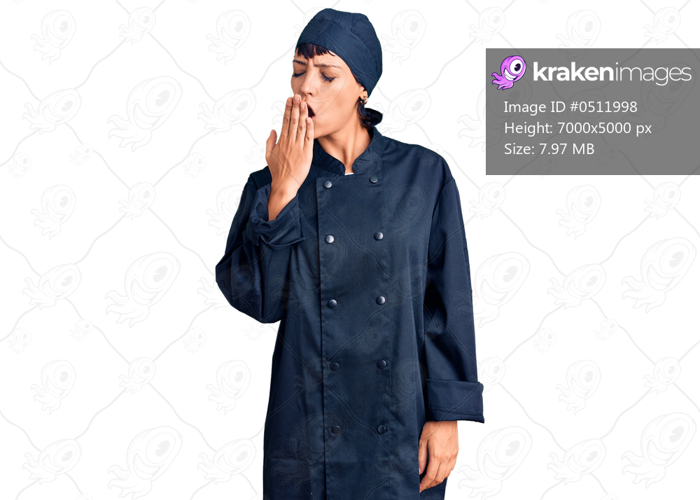 Young brunette woman with short hair wearing professional cook uniform bored yawning tired covering mouth with hand. restless and sleepiness. 