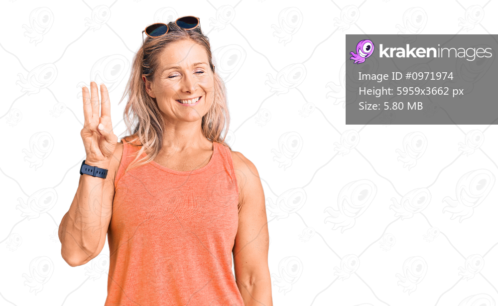 Middle age fit blonde woman wearing casual summer clothes and sunglasses showing and pointing up with fingers number three while smiling confident and happy. 