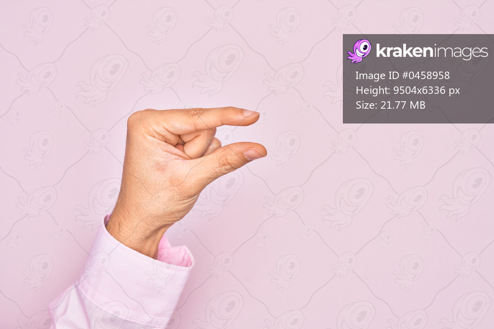 Hand of caucasian young man showing fingers over isolated pink background picking and taking invisible thing, holding object with fingers showing space
