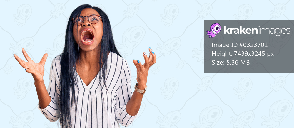 Young african american woman wearing casual clothes and glasses crazy and mad shouting and yelling with aggressive expression and arms raised. frustration concept. 