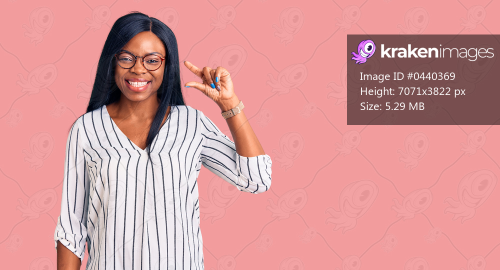 Young african american woman wearing casual clothes and glasses smiling and confident gesturing with hand doing small size sign with fingers looking and the camera. measure concept. 