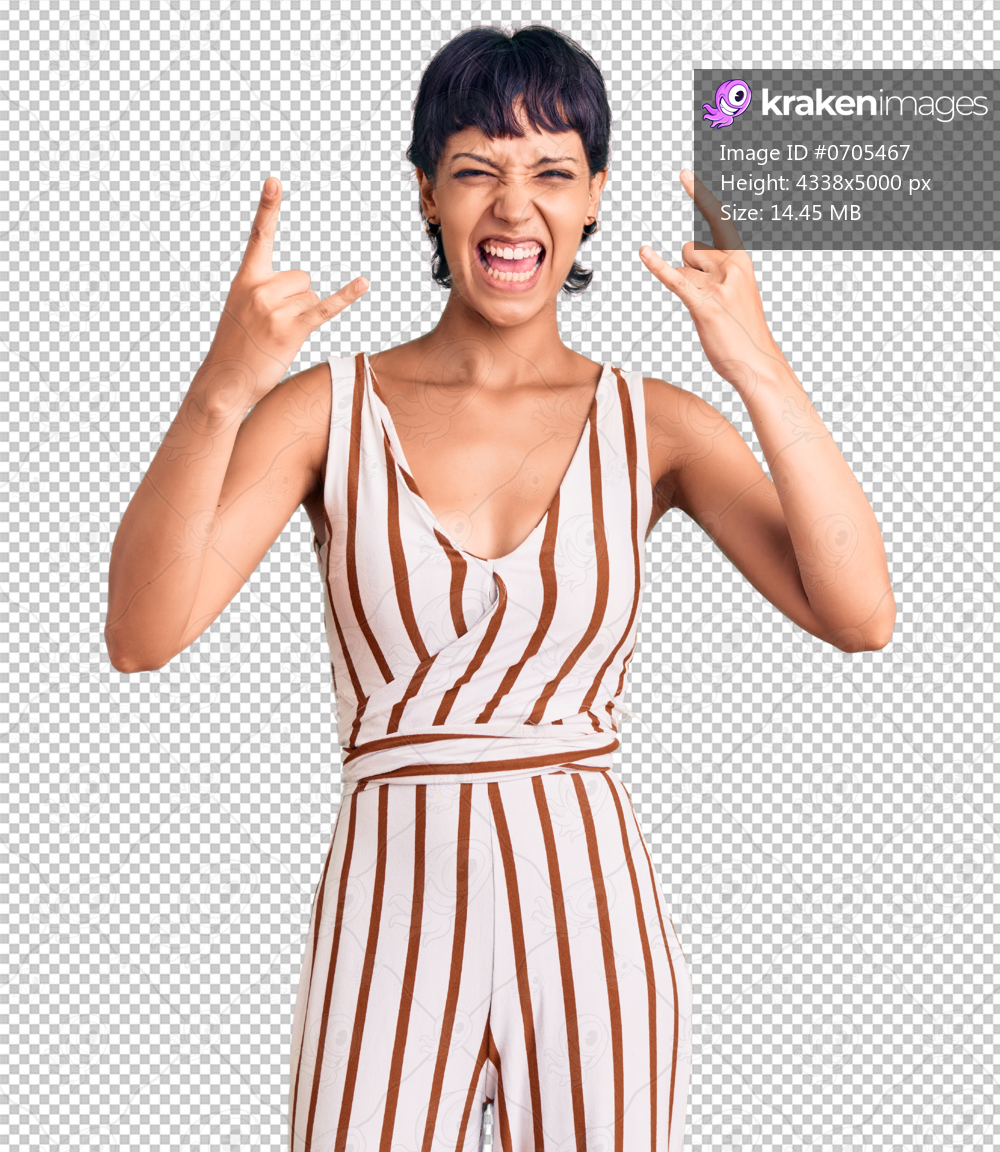 Young brunette woman with short hair wearing summer outfit shouting with crazy expression doing rock symbol with hands up. music star. heavy concept.