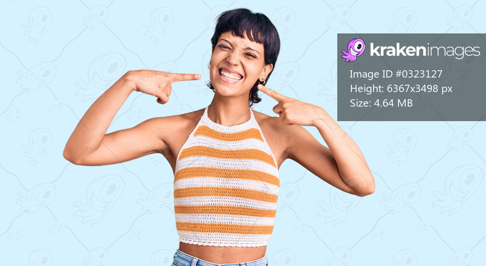 Young brunette woman with short hair wearing casual clothes smiling cheerful showing and pointing with fingers teeth and mouth. dental health concept. 