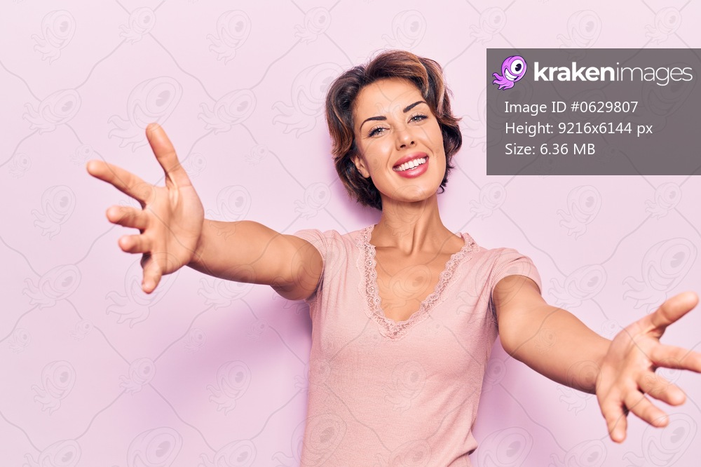 Young beautiful woman wearing casual clothes looking at the camera smiling with open arms for hug. cheerful expression embracing happiness. 