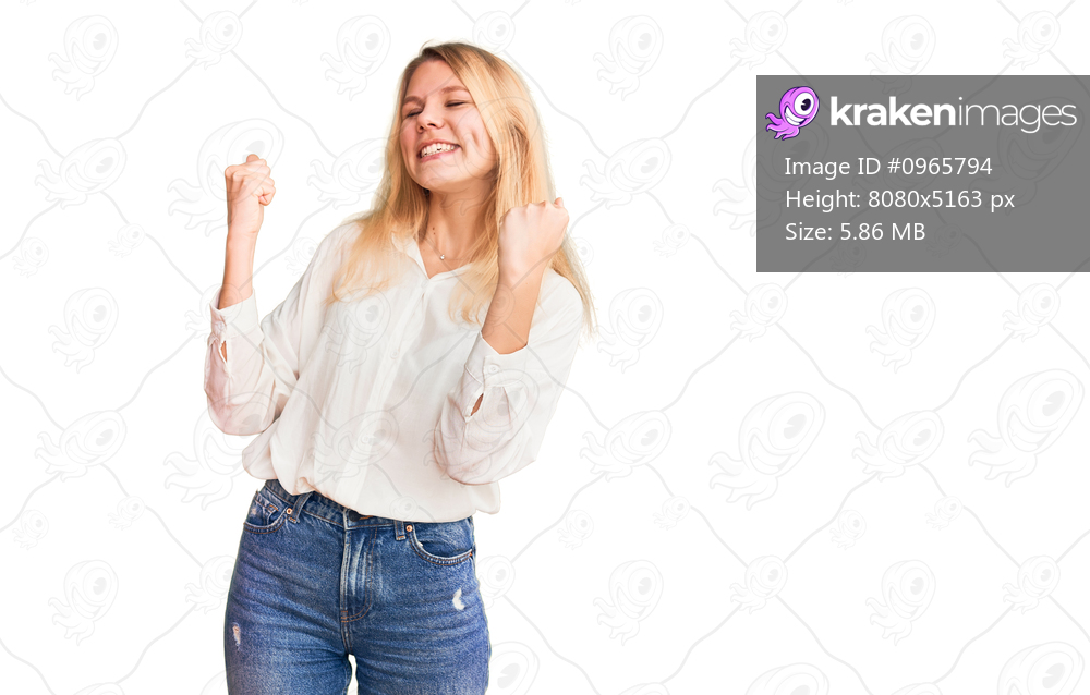 Young beautiful blonde woman wearing casual shirt very happy and excited doing winner gesture with arms raised, smiling and screaming for success. celebration concept. 