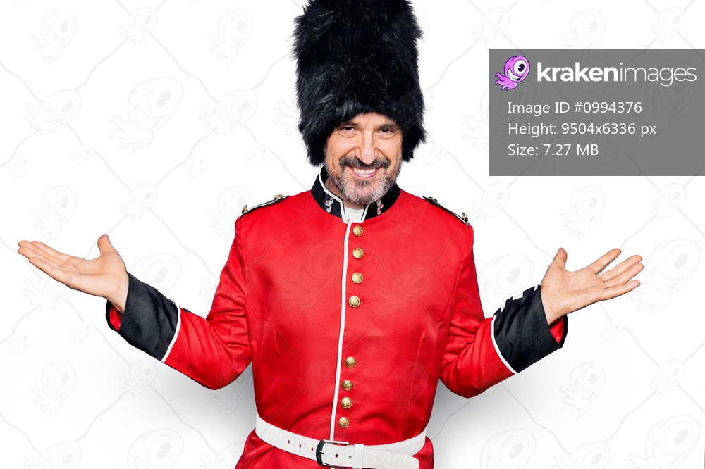 Middle age handsome wales guard man wearing traditional uniform over white background smiling showing both hands open palms, presenting and advertising comparison and balance