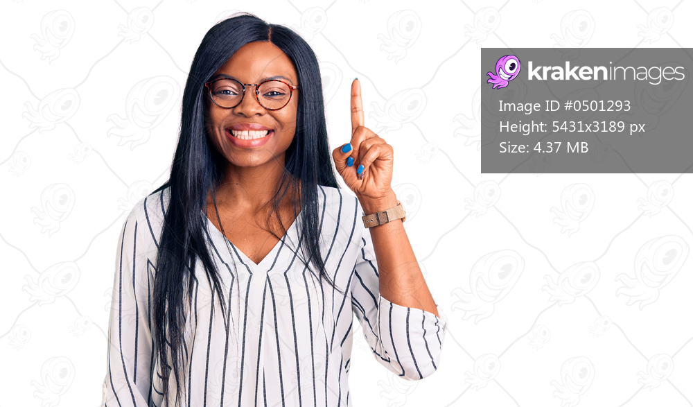 Young african american woman wearing casual clothes and glasses showing and pointing up with finger number one while smiling confident and happy. 