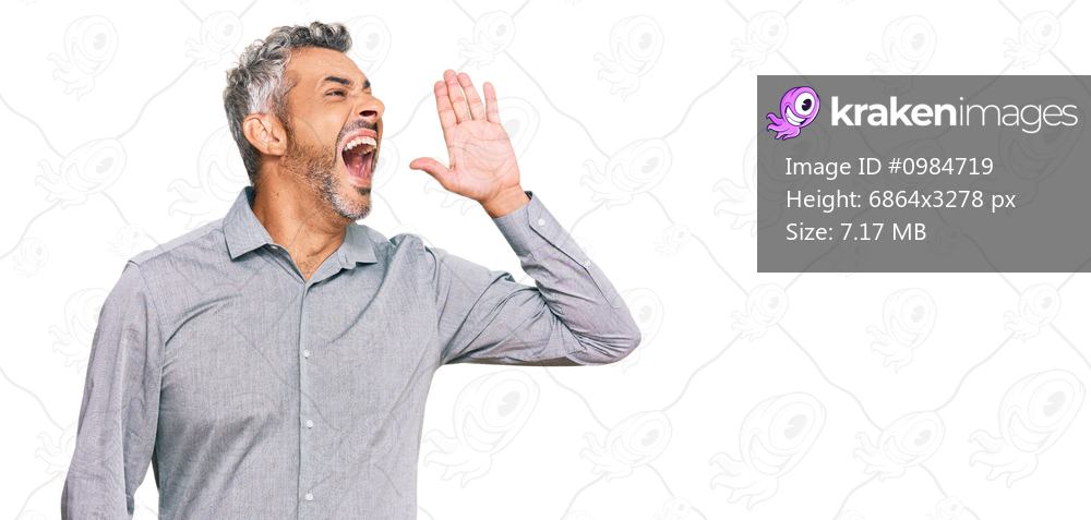 Middle age grey-haired man wearing casual clothes shouting and screaming loud to side with hand on mouth. communication concept. 