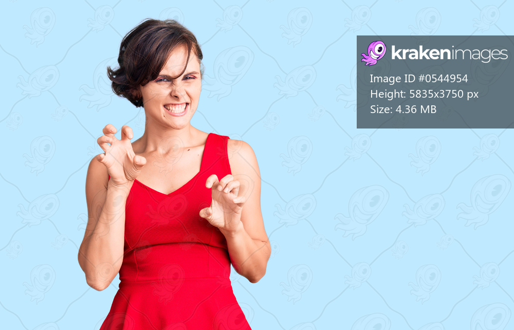 Beautiful young woman with short hair wearing casual style with sleeveless shirt smiling funny doing claw gesture as cat, aggressive and sexy expression 